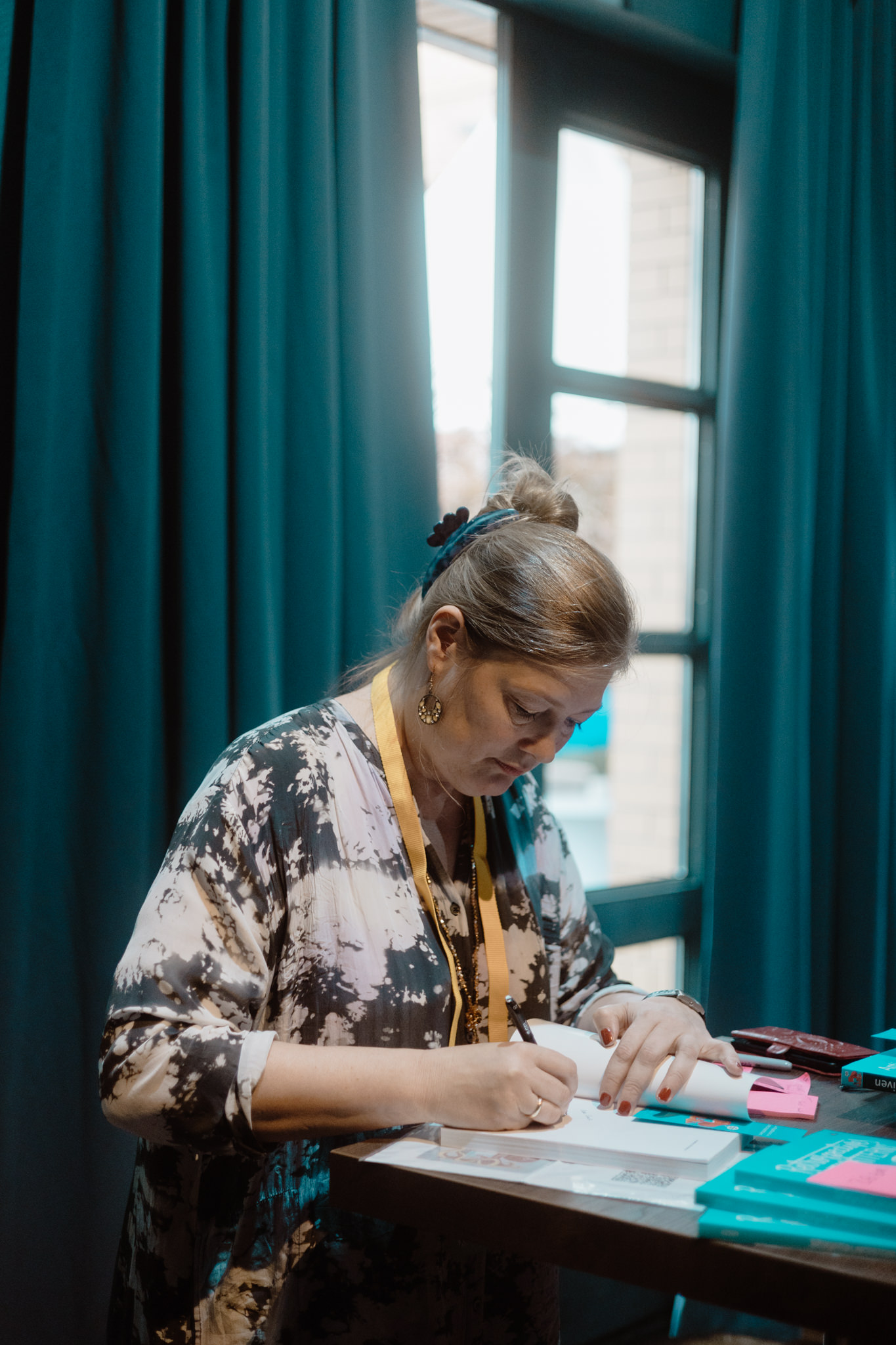 Author signing a book at the window