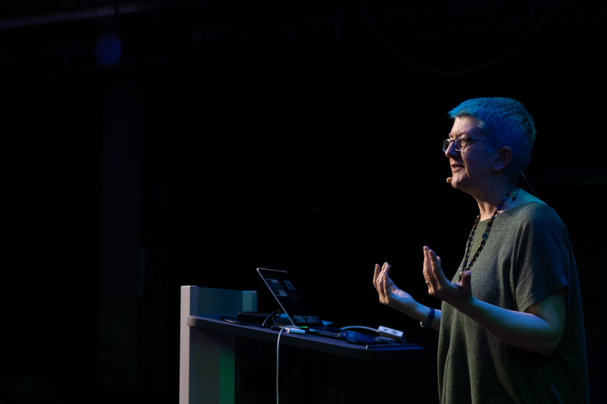 Speaker gesturing at the lectern during a talk