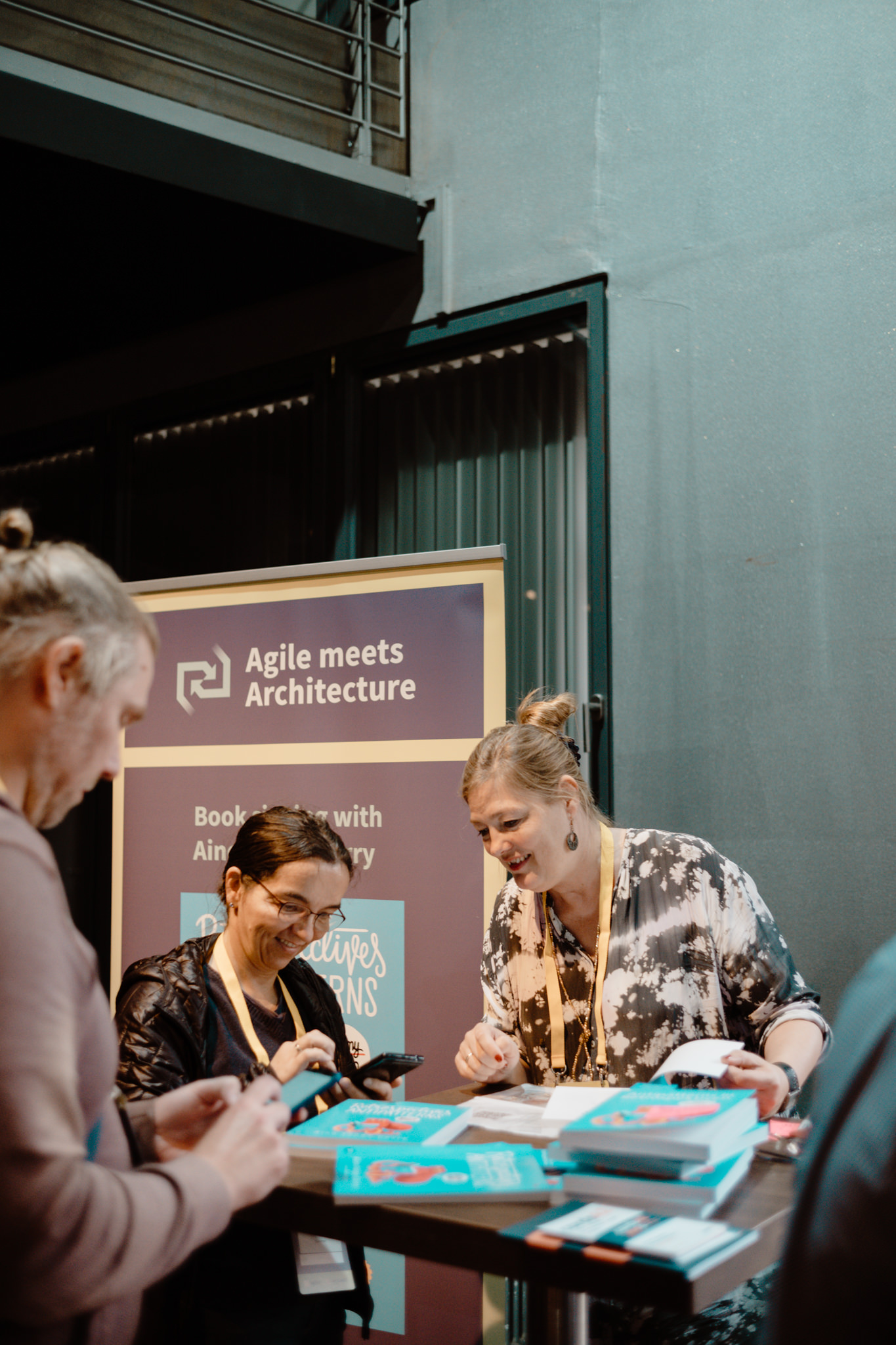Attendees at the registration table by the conference banner