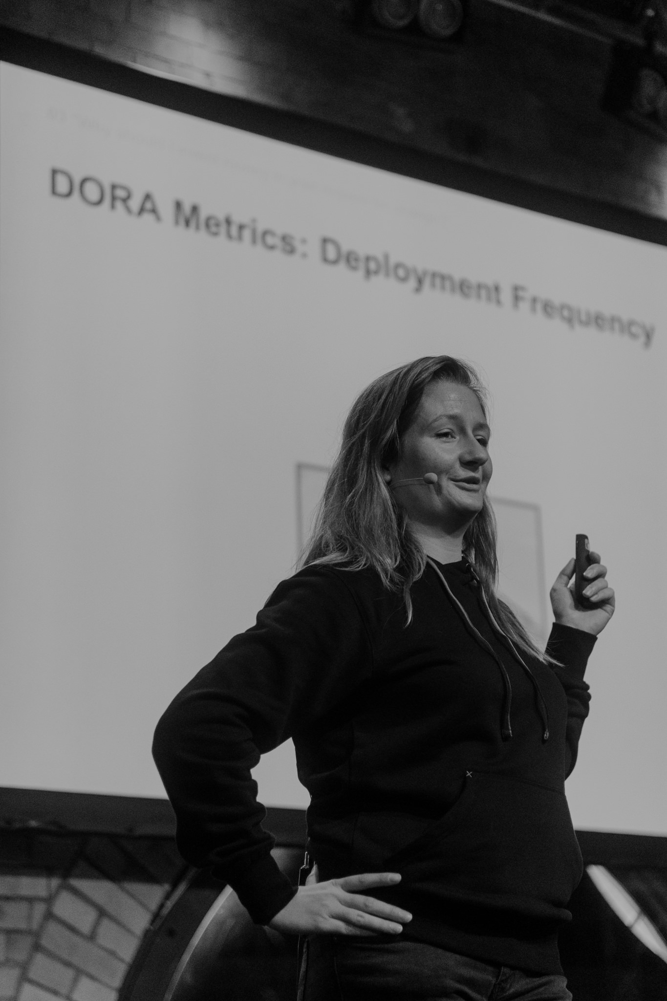 Speaker presenting DORA metrics on stage