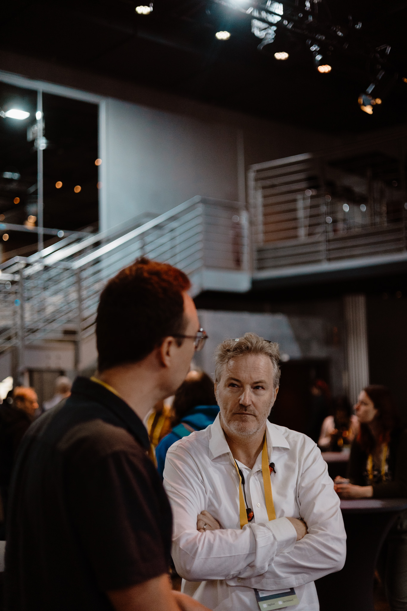 Two attendees in conversation in the foyer